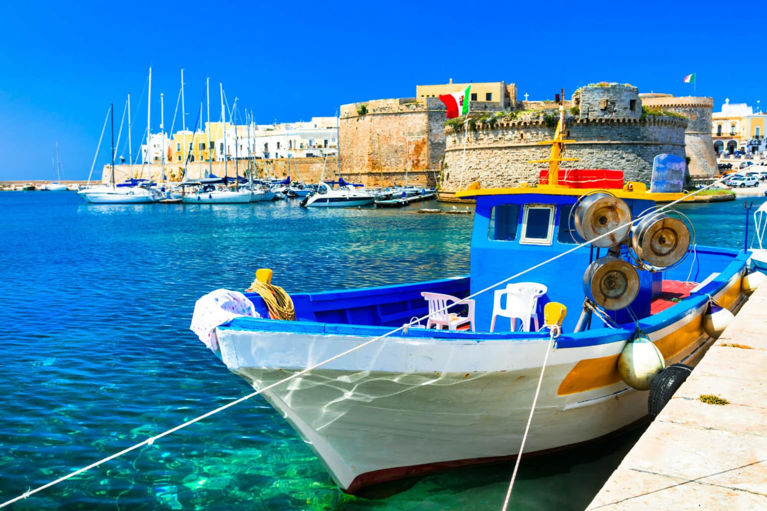 Old port of Gallipoli, view with castle amd boats, Puglia