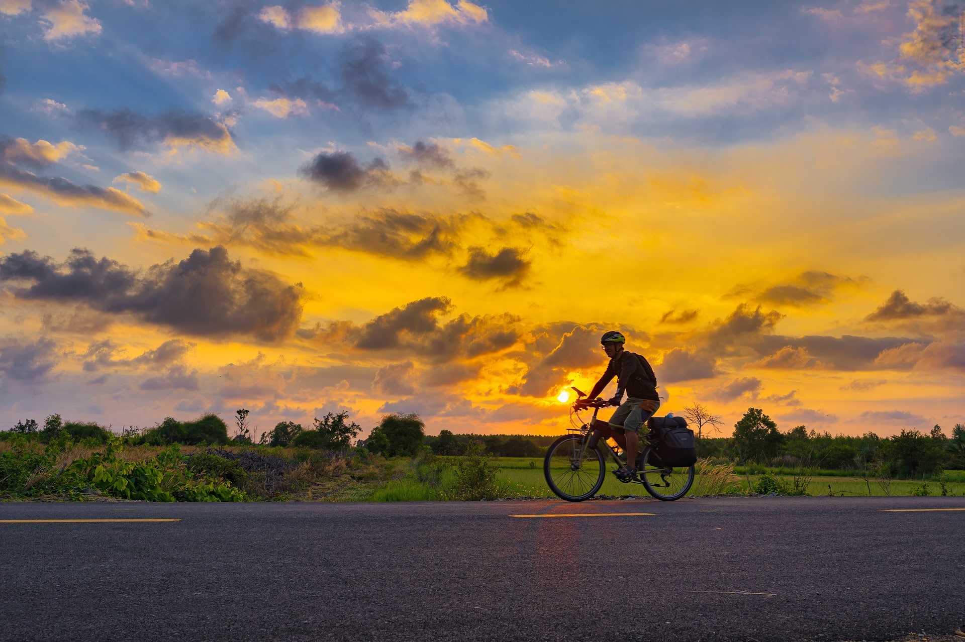 A man cycling at sunset, South Italy